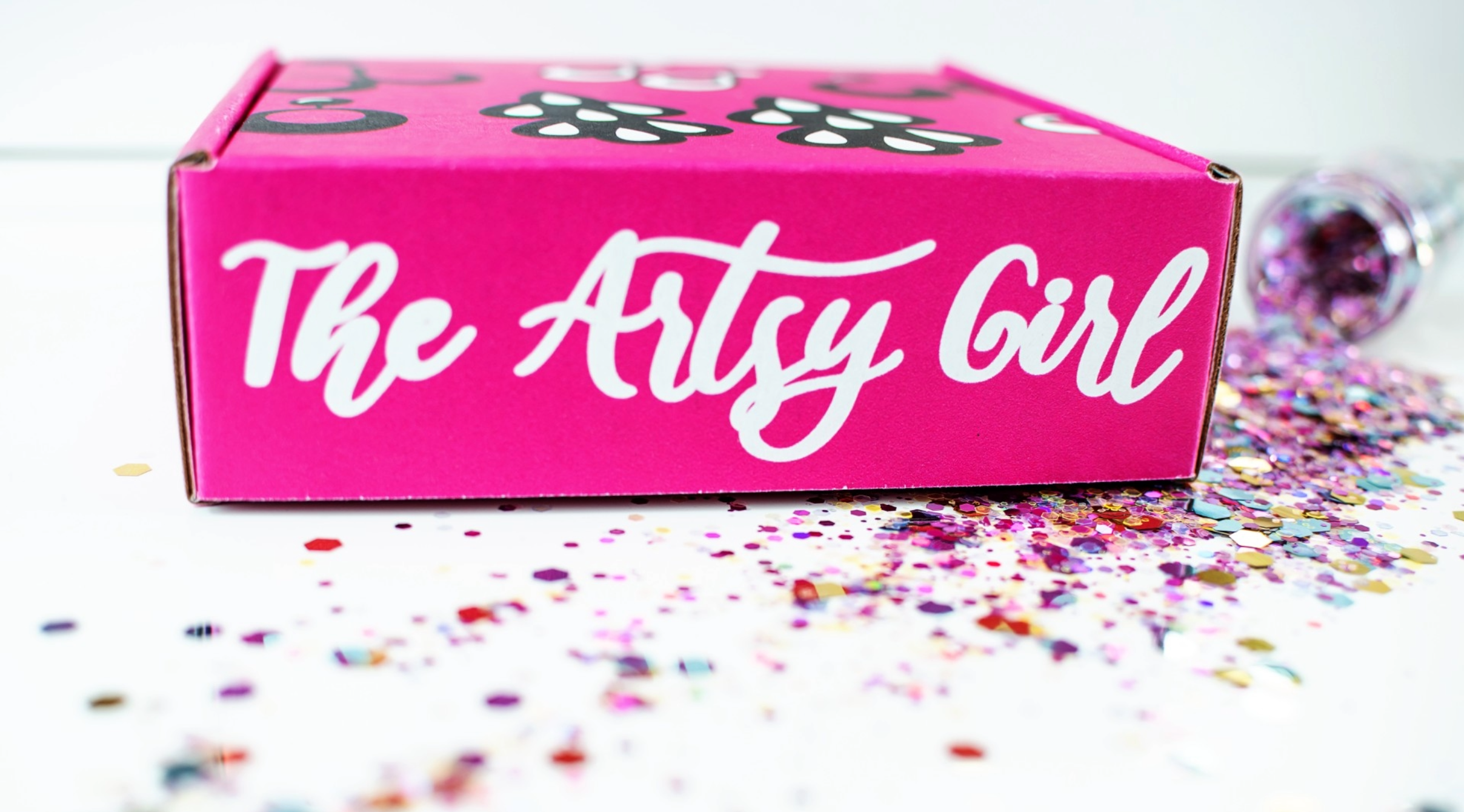 pink custom mailer box on white background with colorful confetti