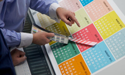 Printed calendar being checked for color accuracy.