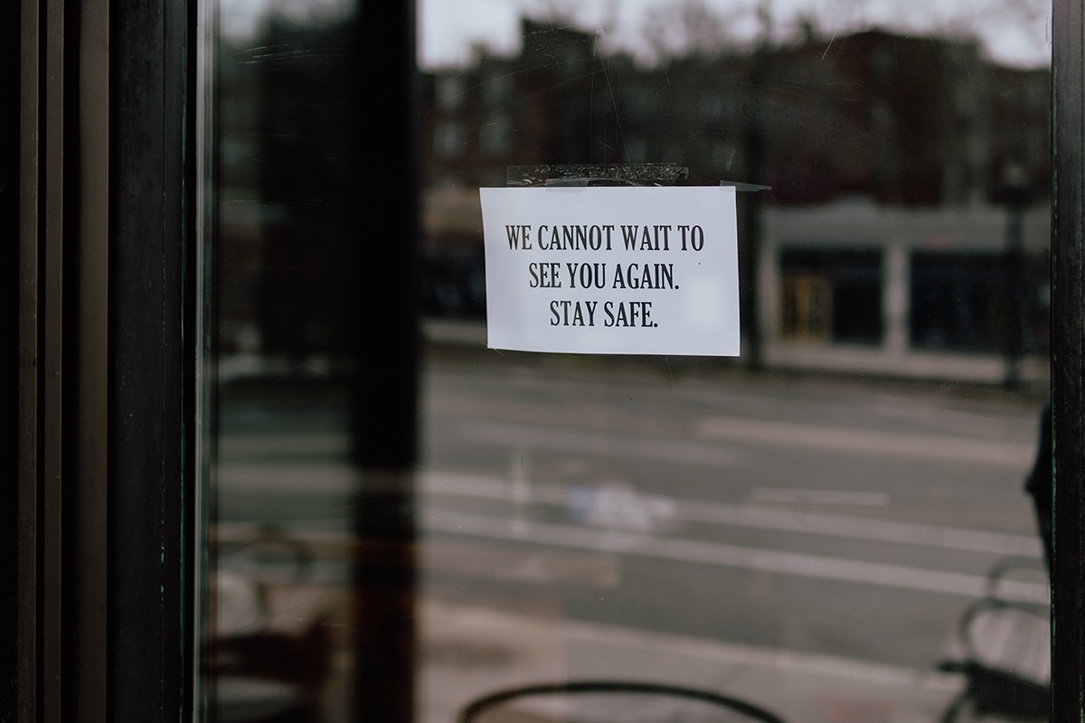 business closed stay safe sign on glass door 