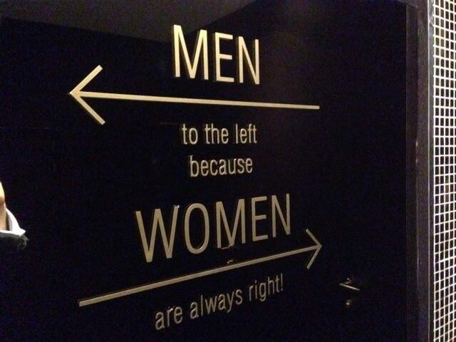 A playful restroom sign indicating directions for men and women