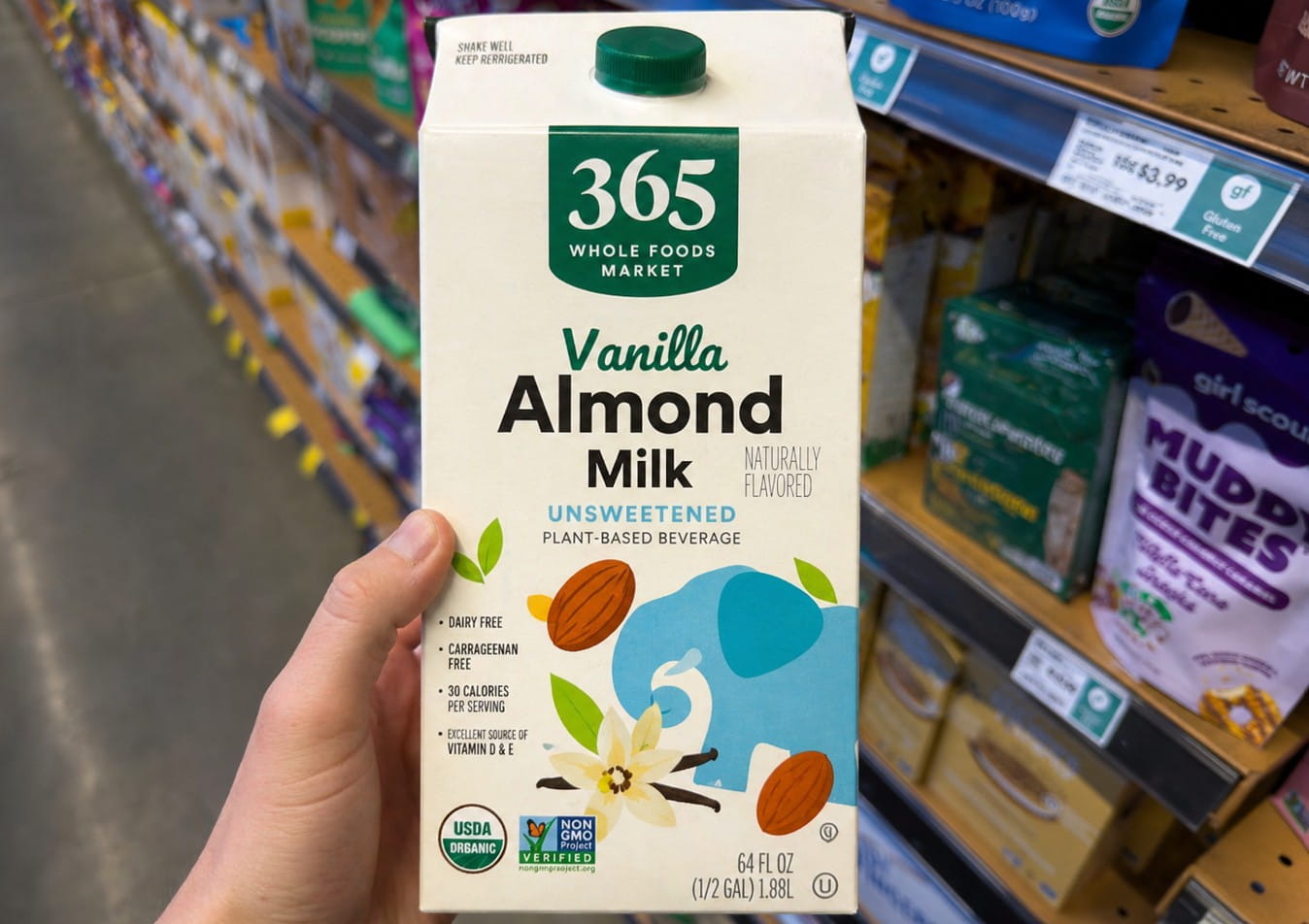 Holding a carton of vanilla almond milk in a grocery aisle