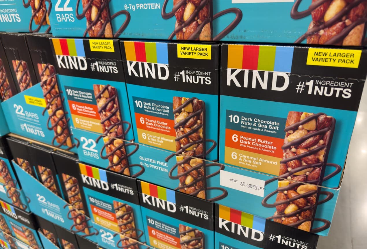 Stacks of KIND snack bar boxes displayed on a retail shelf