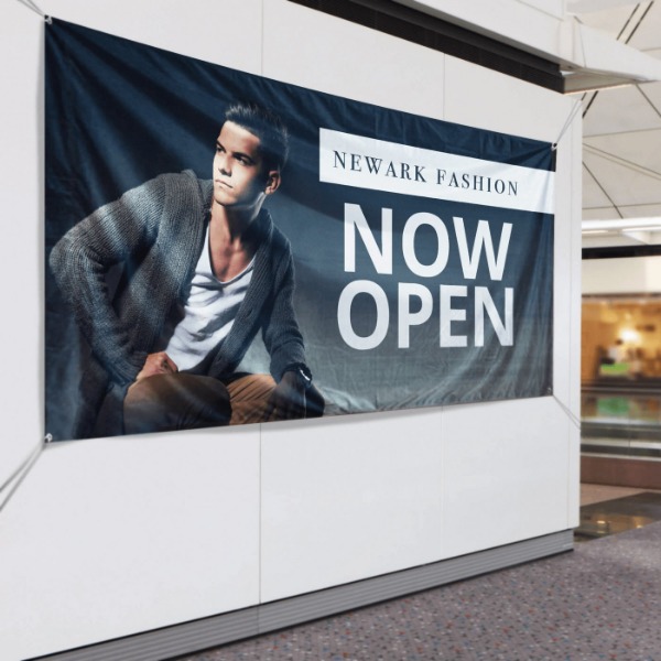 Large promotional fabric banner with retail advertisement design and lifestyle imagery