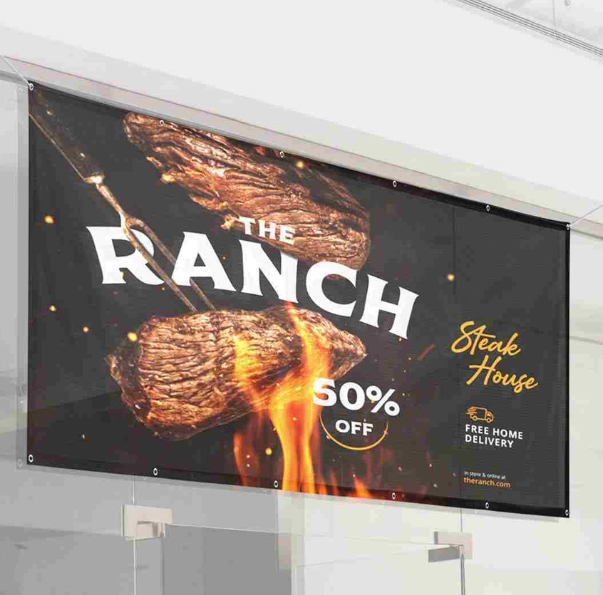 A large outdoor banner advertising a steakhouse promotion