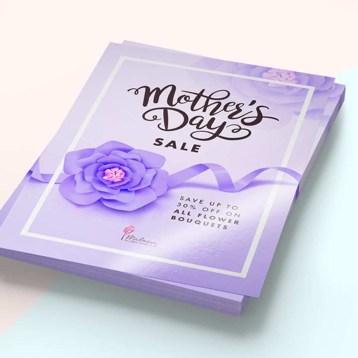 Stack of printed purple Mother's Day sale flyers