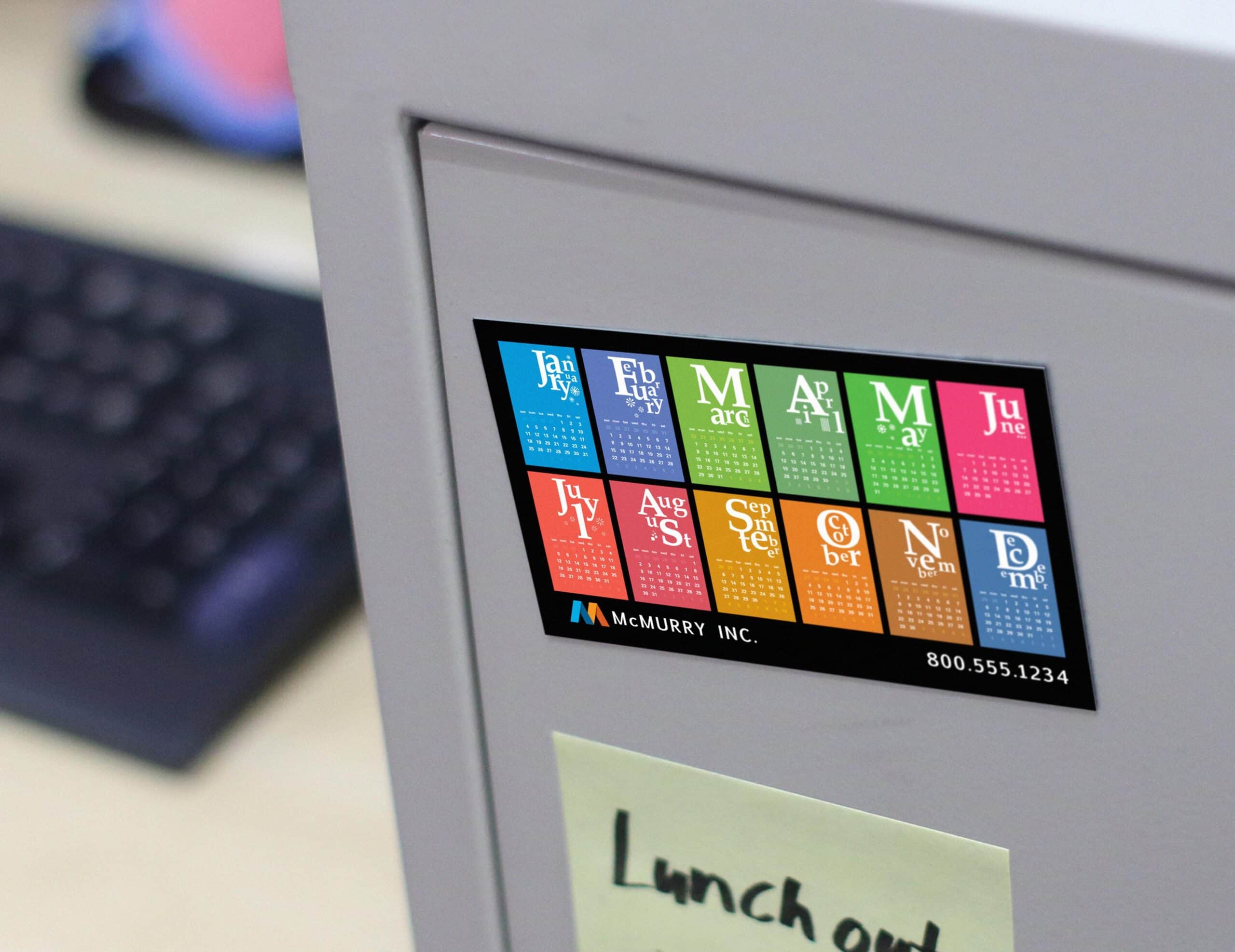 Multicolored magnetic calendar displayed on a metal office surface