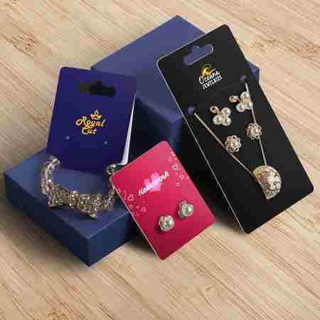 Assorted branded jewelry display cards featuring earrings and necklaces