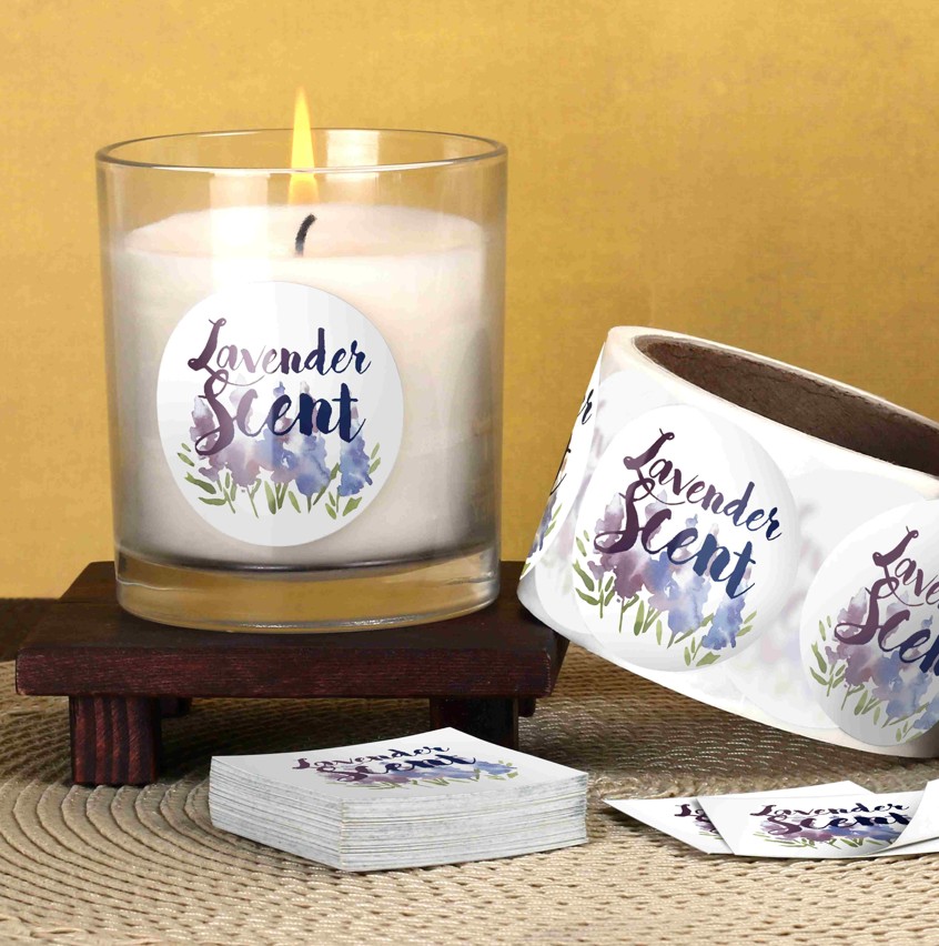 Lit candle in a glass jar with a custom floral printed label