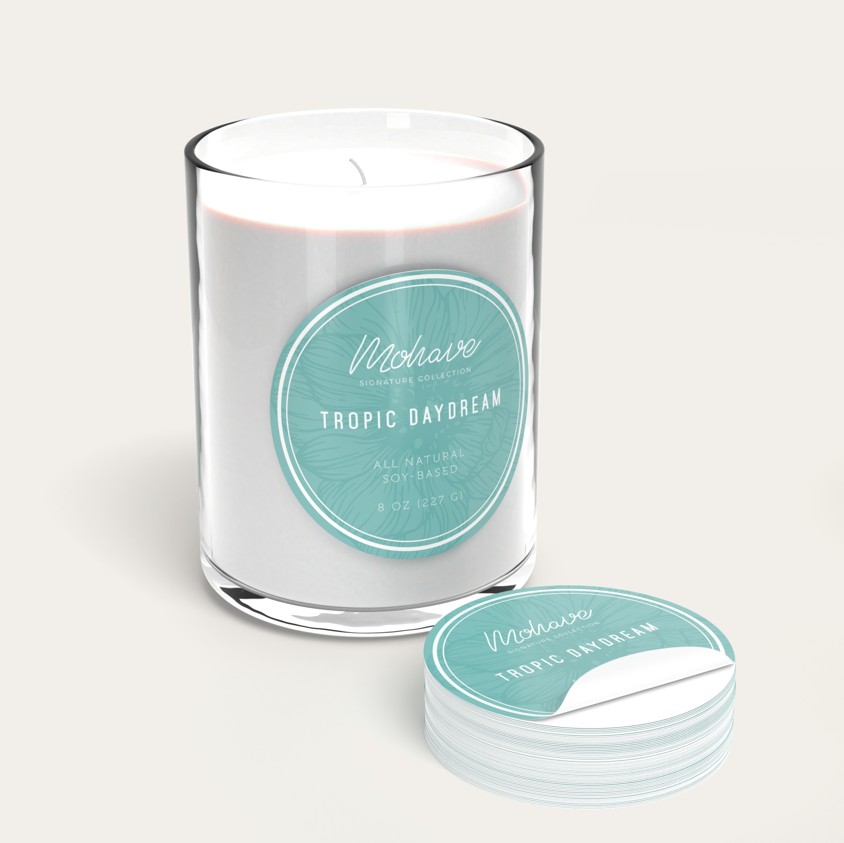 Glass candle jar with a round teal label