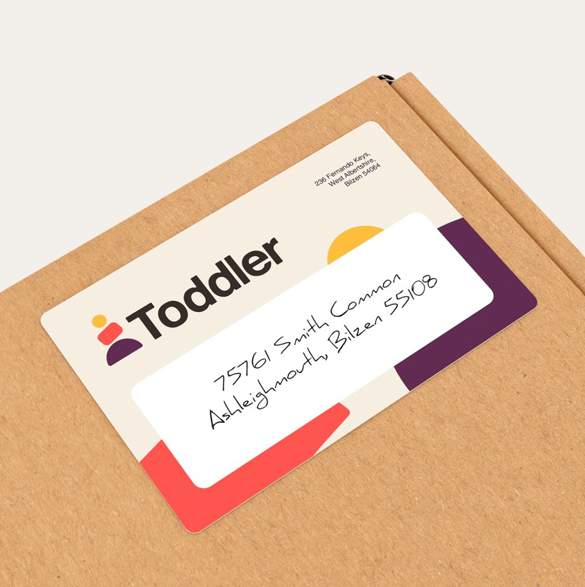 Printed custom shipping label adhered to a corrugated cardboard box
