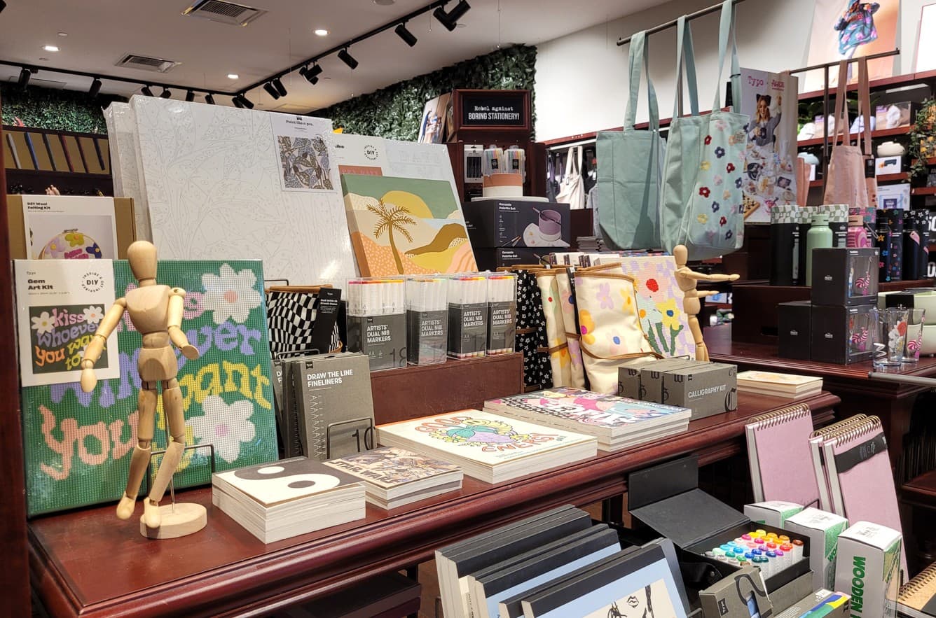 A boutique stationery display with printed notebooks and accessories