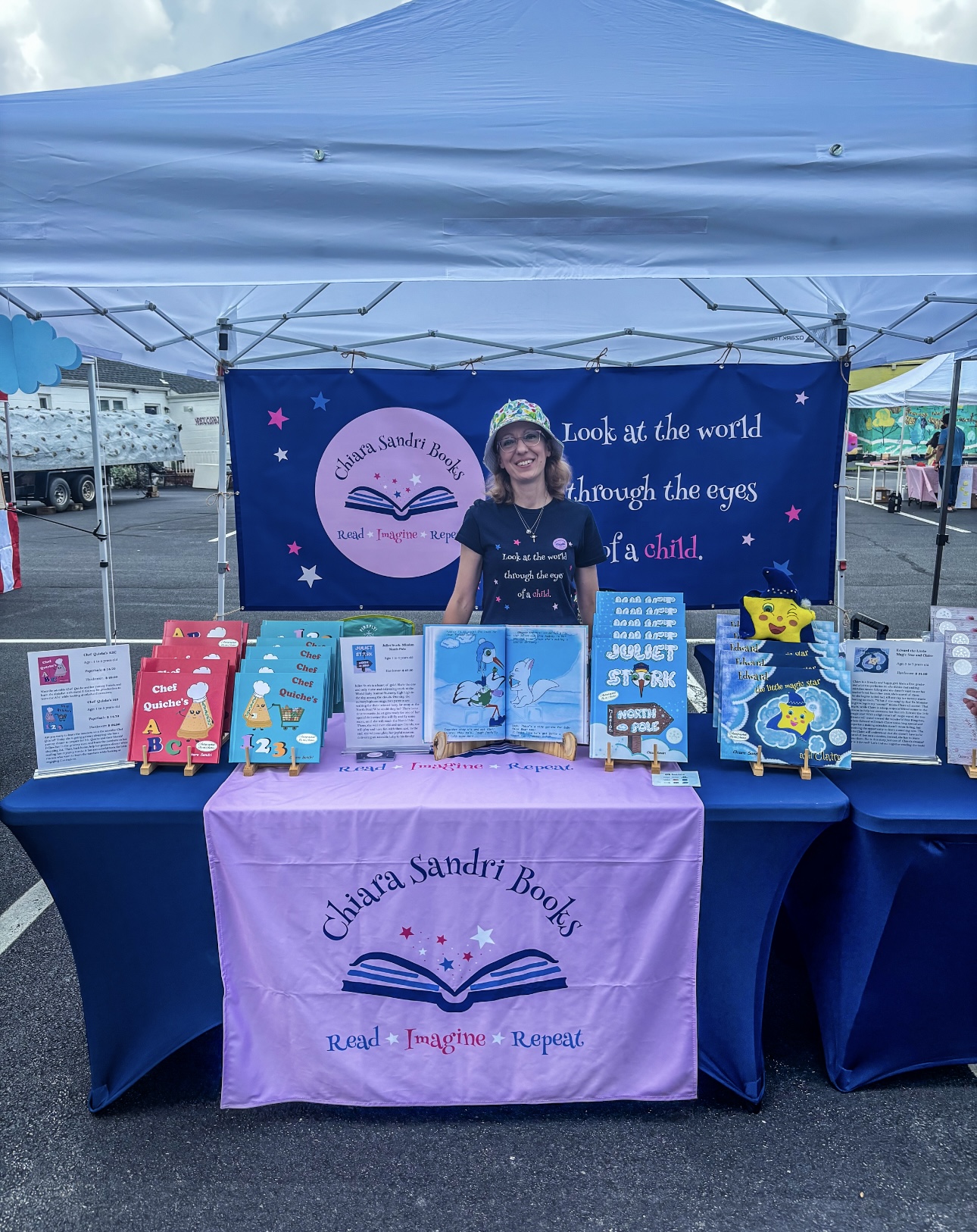 A branded book booth setup with children’s books displayed on a table