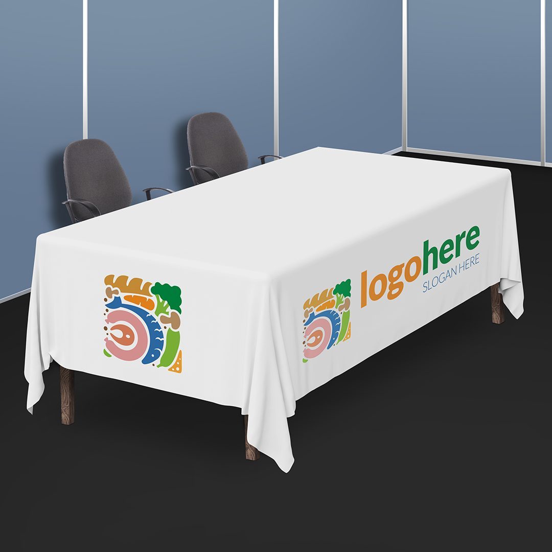A rectangular table covered with a custom printed tablecloth displaying a logo
