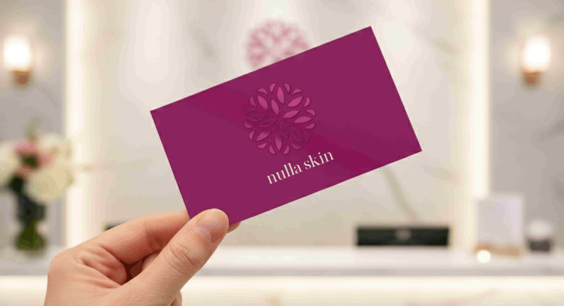 A hand holding a purple cosmetologist business card inside a salon setting