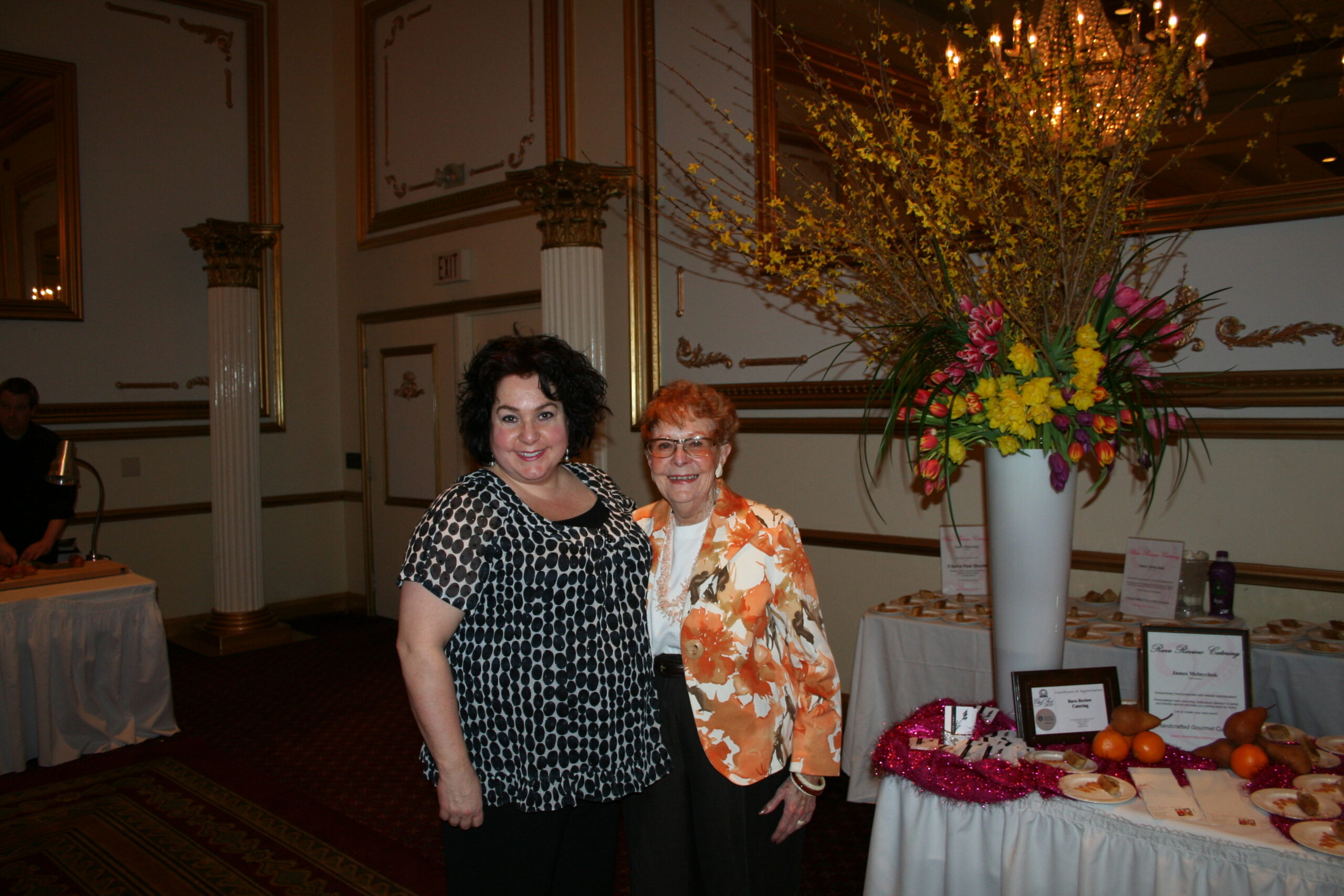 beautiful women mother and daughter at an event smiling