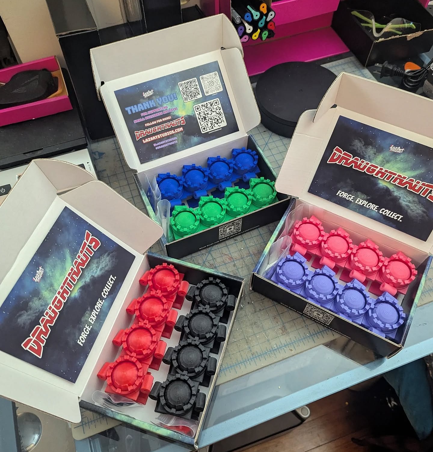 open boxes on a table with colorful contents inside