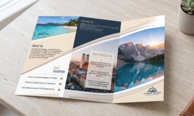 Travel agency brochure displayed flat on a marble surface showing scenic photos