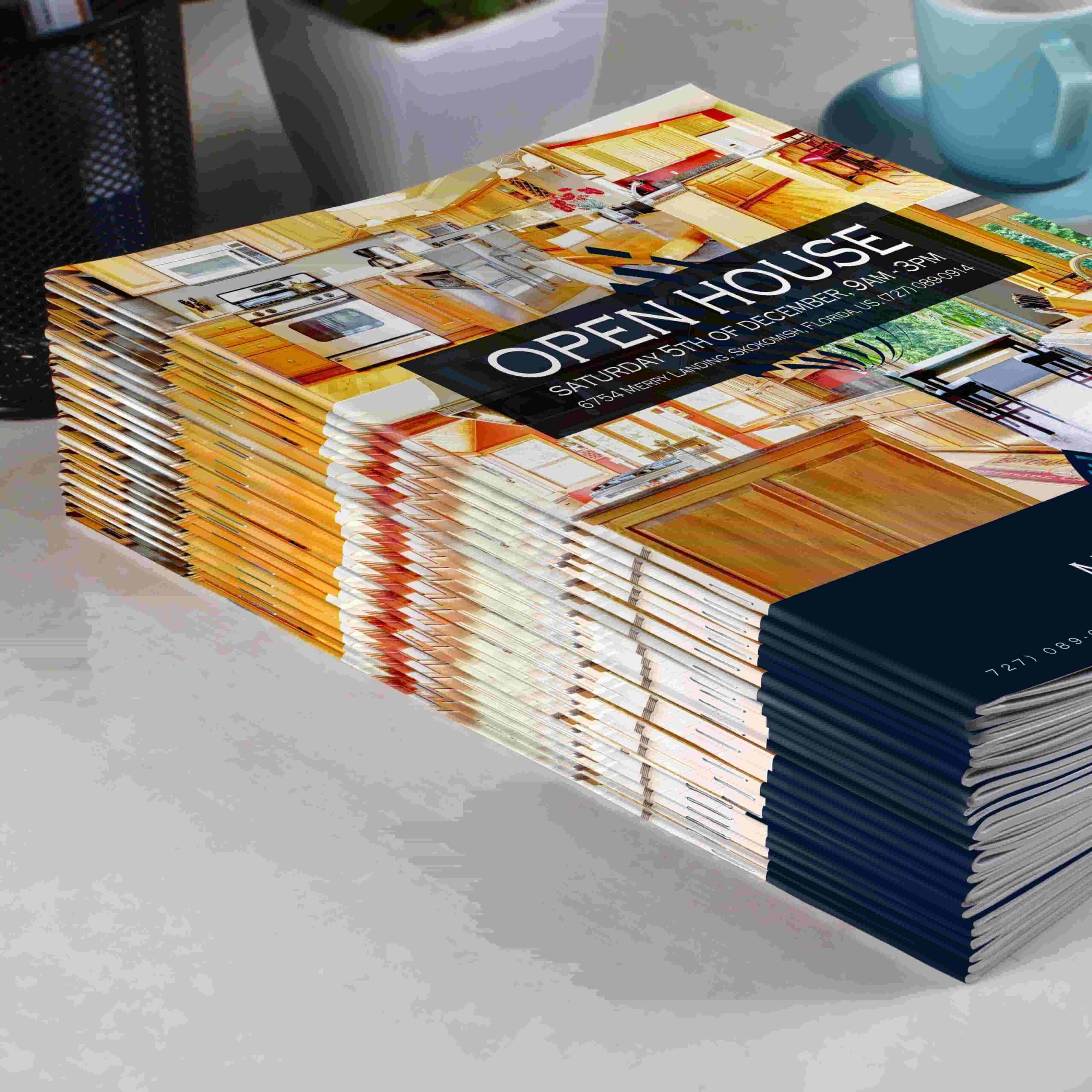 Stack of printed real estate booklets on a desk